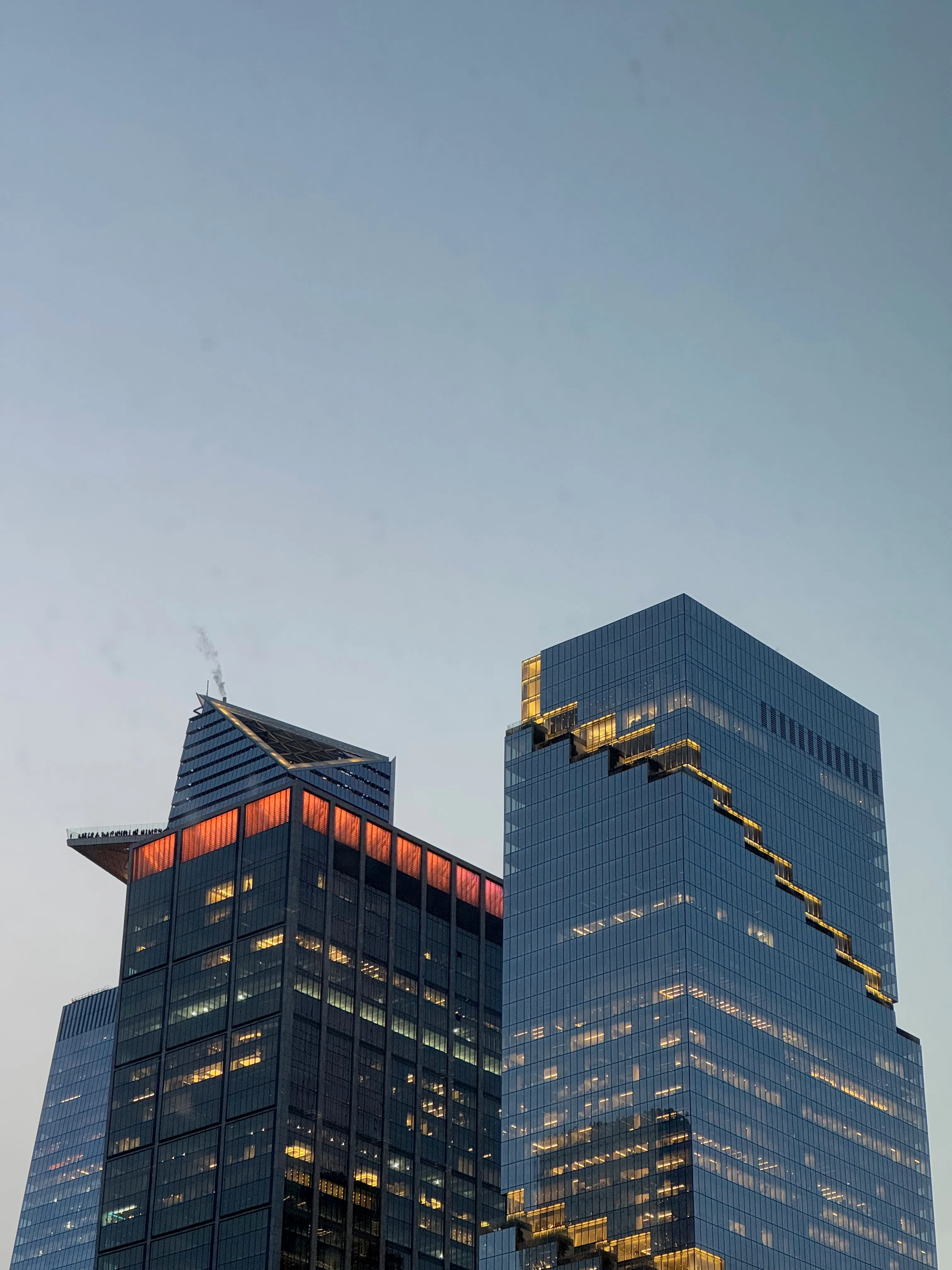 Photo of two buildings with glass exteriors