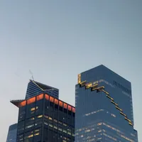 Photo of two buildings with glass exteriors